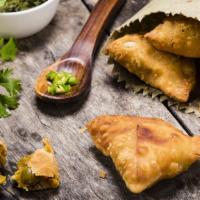 Vegetable Samosa · Two delicate fresh made pastries filled with potatoes and peas.
