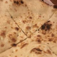 Plain Naan · Naan (famous Indian breads) are baked on the walls of our tandoor oven & brushed with fresh ...