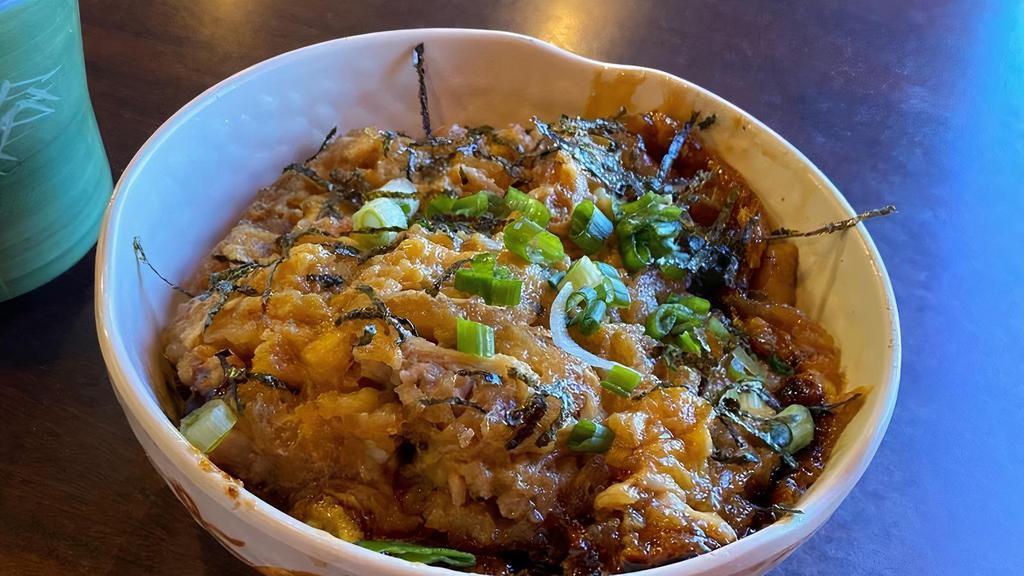 Katsu Donburi · Deep fried pork cutlet, eggs, cooked in sauce over rice.