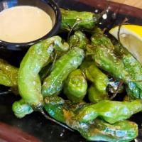 Shishito Peppers · Japanese snacking peppers. Flash fried and served with lemon and house 