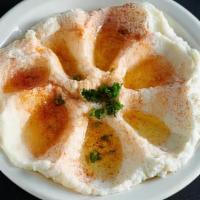 Foul With Hummus · Fava beans mixed with olive oil, lemon juice, garlic, and topped with diced tomatoes, and pa...