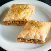 Baklava · Thin layers of filo pastry dough made with butter, filled with walnuts, baked and topped wit...