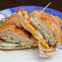 Vegetarian Croissant · Vegetarian sandwich, crispy hash brown, melted cheese, cucumber, tomato, lettuce and zesty a...