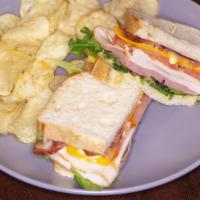 Singles Club · Turkey, ham, bacon, lettuce and tomato piled onto toasted sourdough and drizzled with honey ...