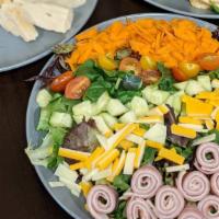 Kitchen Sink Salad · Spring mix, shredded carrot, cucumber, tomato, Cheddar and provolone and ham and turkey. Ser...