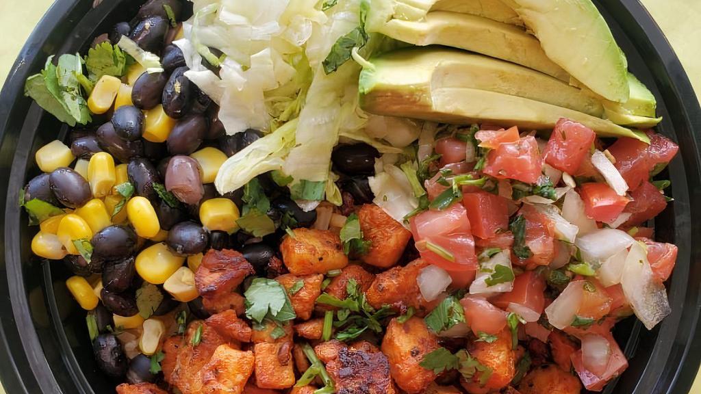 Rice Chicken Bowl · A rice bed topped with grill chicken grilled onions avocado black beans relish lettuce sour cream and lime.