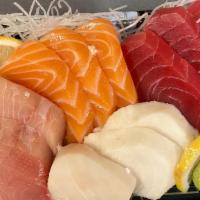 Sashimi Combination · Three pieces of fresh tuna, three pieces salmon, three pieces yellow tail three pieces white...