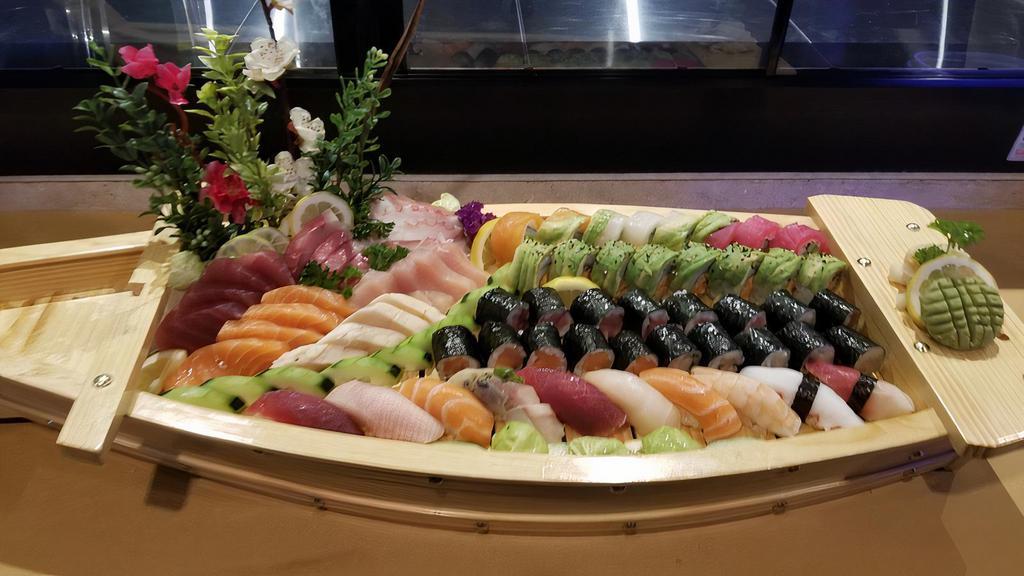 Love Boat · 24 pieces of assorted fresh sashimi and 10 pieces of assorted sushi with rainbow, Manhattan, tuna roll, salmon roll and yellowtail roll.