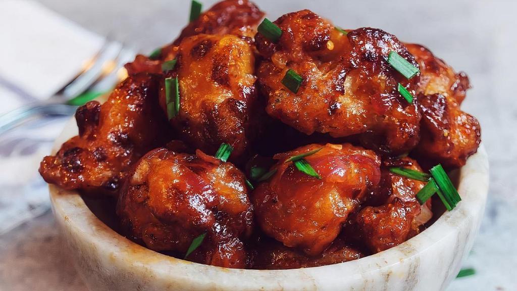 Gobi Manchurian · Indo-Chinese delight. Cut cauliflower pieces, battered, fried, and sauteed over sweet, spice & tangy Manchurian sauce.