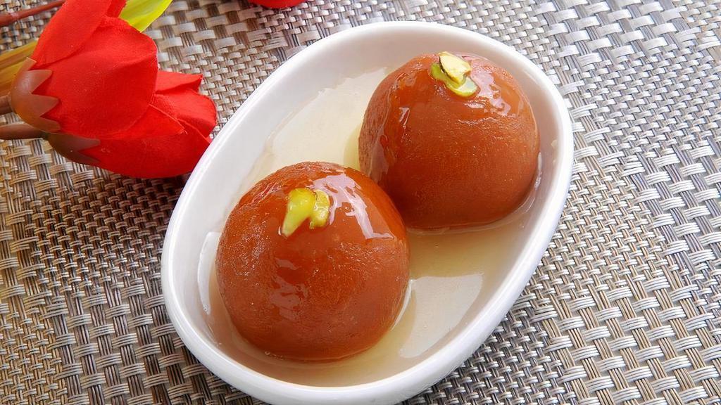 Gulab Jamun · deep-fried dumplings/donuts  made of dried milk are dipped in a cardamom flavored sugar syrup.