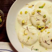 Rasmalai · flattened cheese balls  soaked in malai (clotted cream) flavored with cardamon.