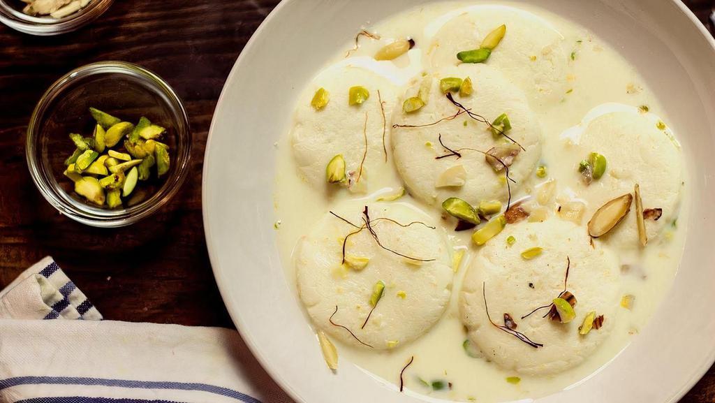 Rasmalai · flattened cheese balls  soaked in malai (clotted cream) flavored with cardamon.