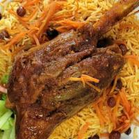 Shank Qabuli · Lamb shank seasoned with natural spices raisons and carrots toping  with basmati rice, salad...