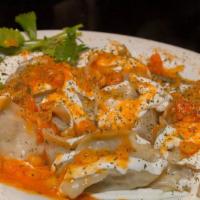 Mantu · Onion and ground lamb filled steamed dumplings, topped with yogurt, and served with mixed ve...