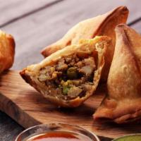 Vegetable Samosa · Turnovers stuffed with spiced boiled peas and potatoes, deep fried.