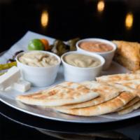 Roasted Garlic Hummus W/ Pita  · Garbanzo bean and tahina dip, served with pita.