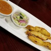 Chicken Satay · Grilled marinated chicken breast tender in yellow curry and coconut milk, served with cucumb...