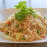 Thai Fried Rice · Wok fried Jasmine rice with onions, tomatoes, peas, carrots, and egg.