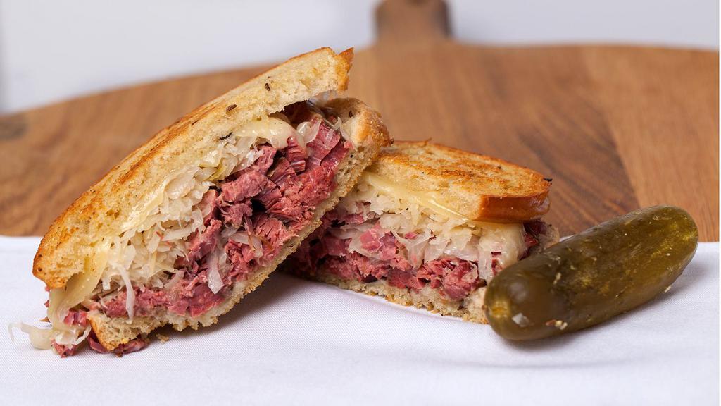 Reuben · House-Cured Corned Beef, Melted Swiss, Sauerkraut, Russian Dressing, Pumpernickel Bagel. Served with choice of pickle and side.