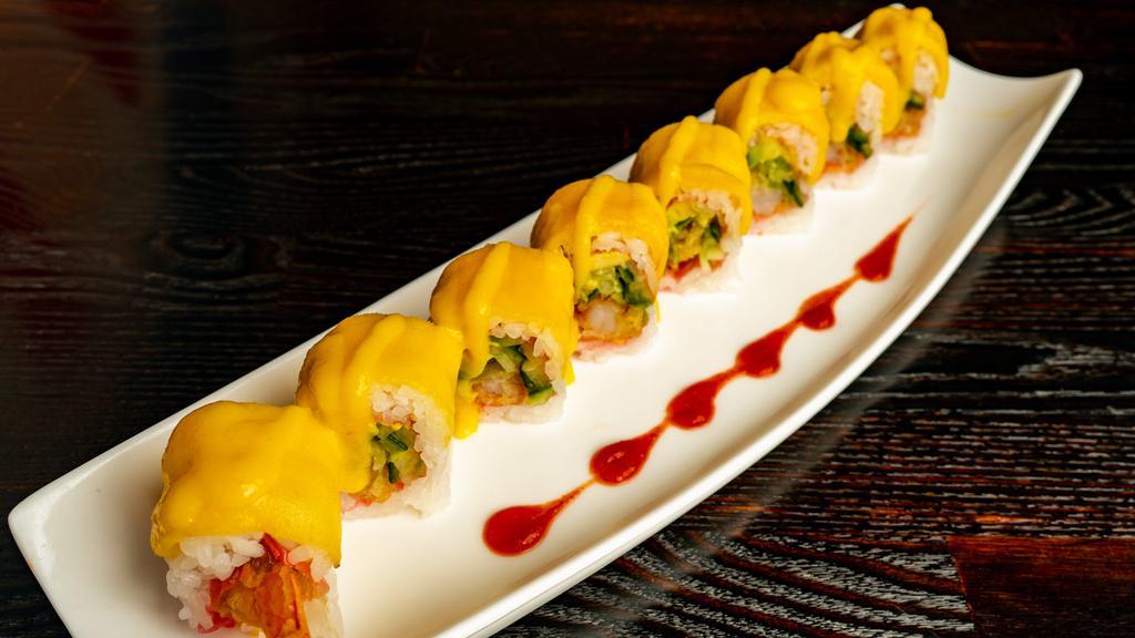 Crazy Mango · New roll. Shrimp tempura, avocado, and cucumber wrapped in soy paper, topped with mango, and mango sauce.