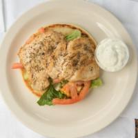 Chicken Pita (Shawarma) · Marinated chicken breast and thigh broiled on a vertical skewer with lettuce, onion, tomatoe...