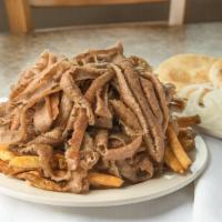 Gyros Plate · Thinly sliced layers of seasonal lamb and beef broiled on a vertical skewer with onion, toma...