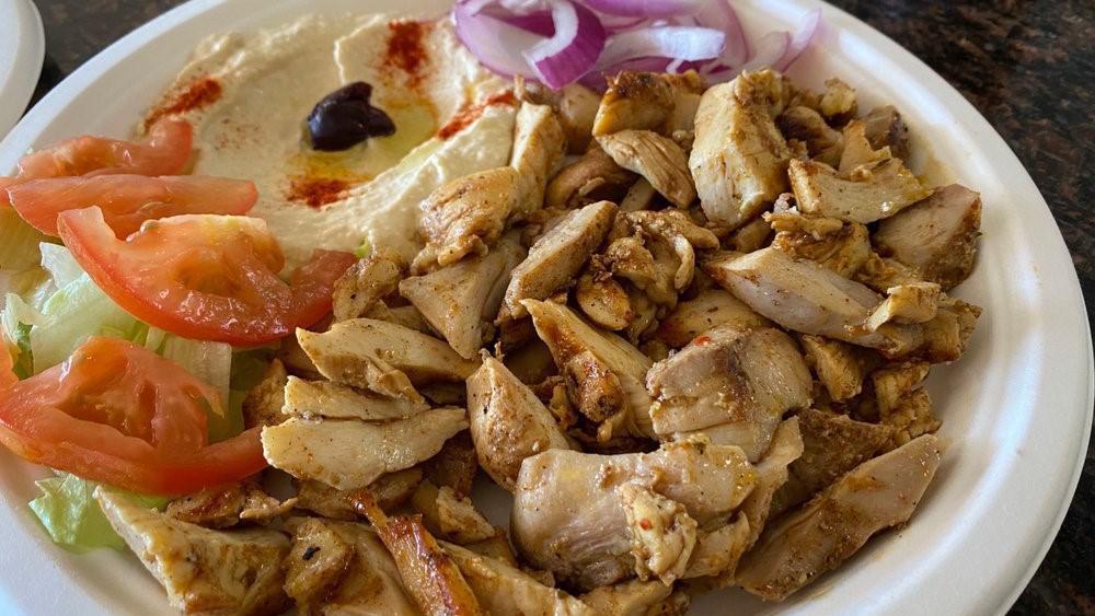 Chicken (Shawarma) Plate · Marinated chicken breast and thigh broiled on a vertical skewer with lettuce, onion, tomatoes, and garlic sauce.