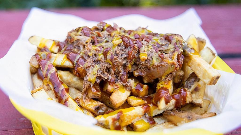 Pulled Pork Fries · Fries topped with slow cooked Carlton Farms pork shoulder, served with your choice of BBQ sauce or bourbon honey mustard.