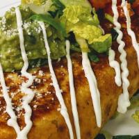 Chimichanga · Served with beans rice, melted cheese inside, guacamole, pico de gallo, queso cotilla and so...