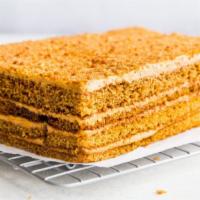 Honey Cake · Moist honeycake layers (think moist,thick graham cracker) with a caramel cream filling
