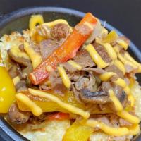 Philly Special · Shaved ribeye steak, peppers, caramelized onions, mushrooms, cheddar cheese sauce, and bread...