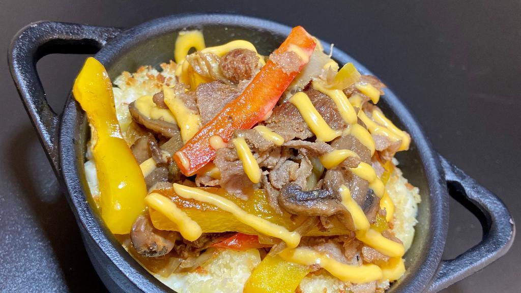Philly Special · Shaved ribeye steak, peppers, caramelized onions, mushrooms, cheddar cheese sauce, and breadcrumbs.