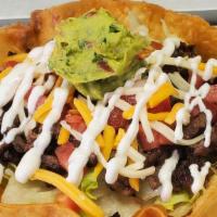 Taco Salad · Large round shell filled with beans, rice, lettuce, diced tomatoes, shredded cheese, sour cr...