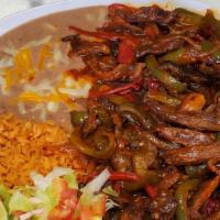 Steak Or Chicken Ranchera · Comes with sliced steak, bell pepper, onion, smothered in ranchera sauce. Rice, refried pint...