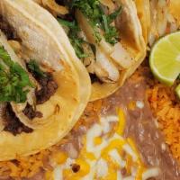 Chicken Taco Plate  · 3 tacos on corn tortillas with onio , cilantro,  and your choice of meat.  Also comes with r...