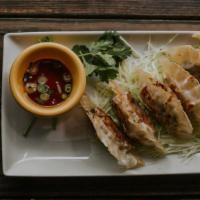 House-Made Pot Stickers · Pan-fried dumplings with a tender filling of diced cabbage, carrots, mushroom, ginger, and s...