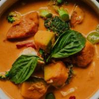 Pumpkin Curry · Hearty chunks of pumpkin simmered in red coconut milk curry, with basil, broccoli and bell p...