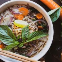 Kati Phở · A plant-based Pho in clear vegetable broth topped with plant based meat, sautéed garlic, bas...
