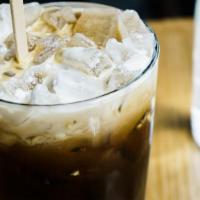 Thai Iced Coffee · Thai style sweetened iced coffee with a dollop of coconut cream on top.