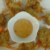 Coconut Prawns (7 Pieces) · Rough and crunchy roasted coconut with thai-style battered prawns. Served with our sweet chi...