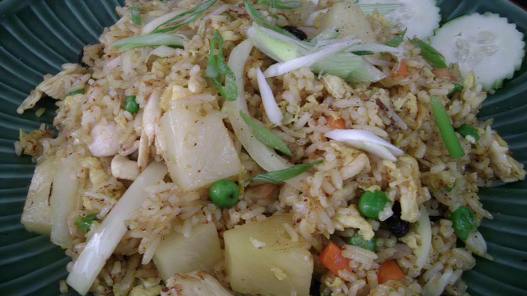 Hawaiian Pineapple Fried Rice · Stir fried with egg, pineapple, cashew nuts, onion, peas and carrot, raisin in yellow curry powder. Topped with green onion.