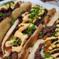 Seoul Dog · Jumbo grilled all beef hot dog, topped with mozzarella cheese, french fry cubes, ribeye beef...