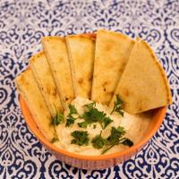 Hummus With Pita · Hummus Spread Made From Mashed Chickpeas, Tahini, Olive Oil, Lemon Juice, Salt & Garlic. Ser...