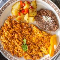 Huevos Con Chorizo · Scrambled eggs with spiced Mexican sausage. Served with refried pinto beans and house potato...