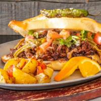 Torta Mexi-Philly · Asada meat grilled with onions, peppers and cheese blend with a spread of refried beans, roa...