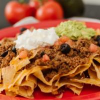 Nacho Supreme · Tortilla chips covered with melted cheese, refried beans, olives, tomatoes, guacamole, sour ...
