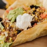 Taco Salad · A large Beef, Chicken or Chile Verde Burrito smothered with enchilada sauce and cheese. Serv...