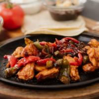 Steak Fajitas · Marinated strips of steak or chicken, bell peppers
and onions served sizzling on a cast iron...