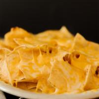 Nachos · A heaping plate of tortilla chips
smothered with melted cheese.