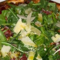 Biaggia · Fig jam base, prosciutto, mozzarella, goat cheese, finished with arugula, shaved part and le...